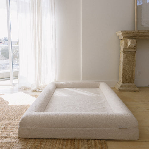 Image of Large/Extra Large Bouclé Dog Bed with cream boucle fabric and memory foam, styled in a spacious living room setting