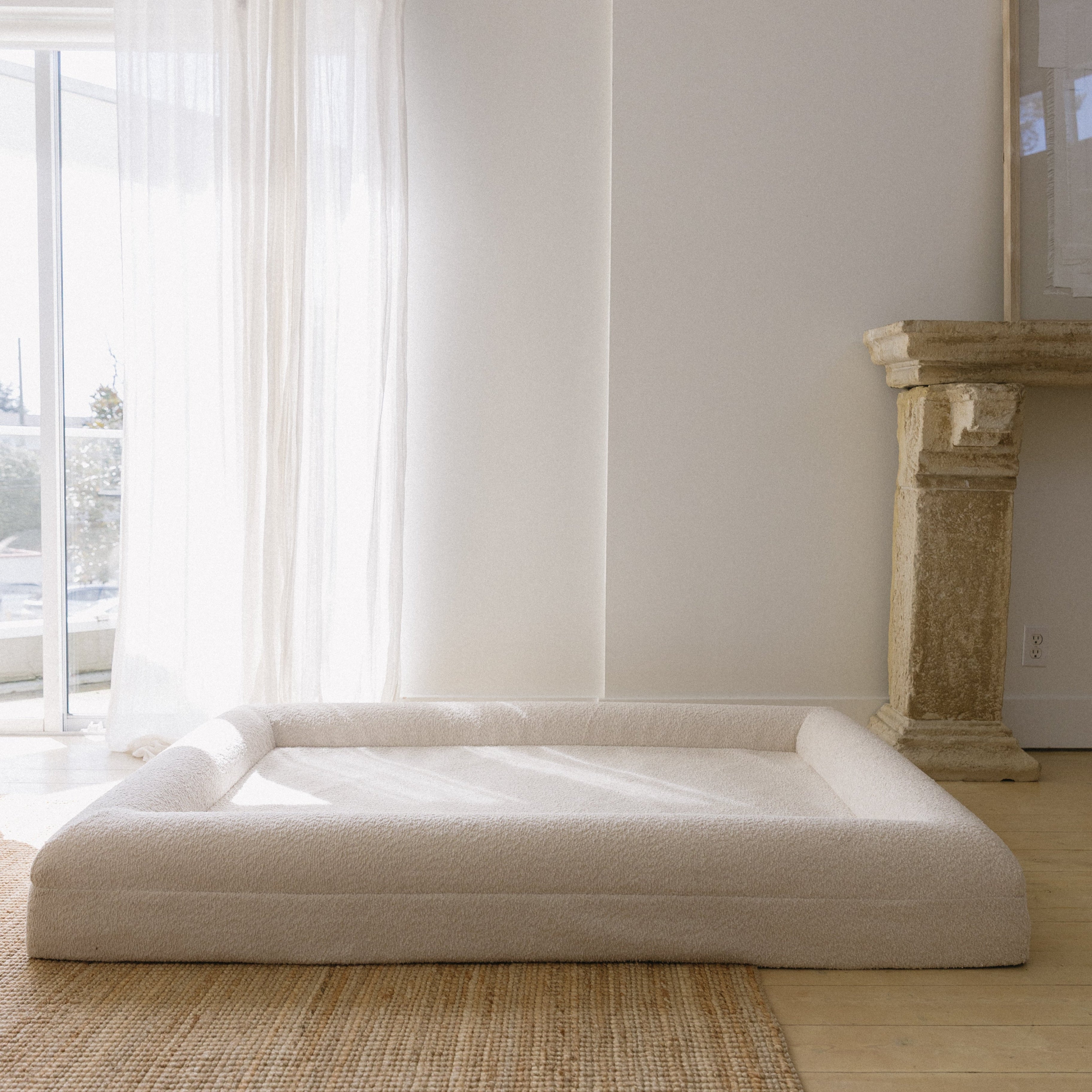 Image of Large/Extra Large Bouclé Dog Bed with cream boucle fabric and memory foam, styled in a spacious living room setting