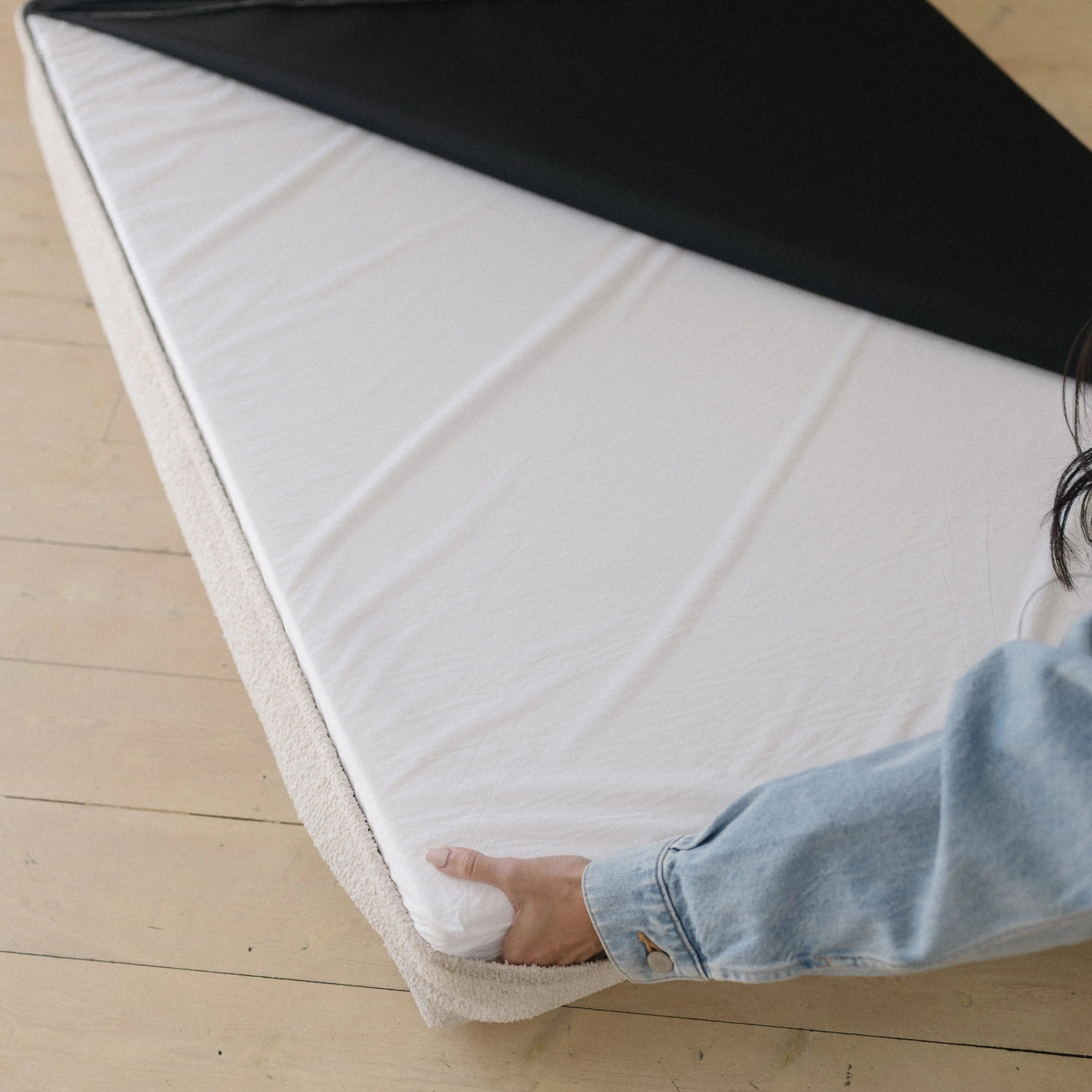 Underside of the dog bed showing the non-slip grip bottom surface and the waterproof lining