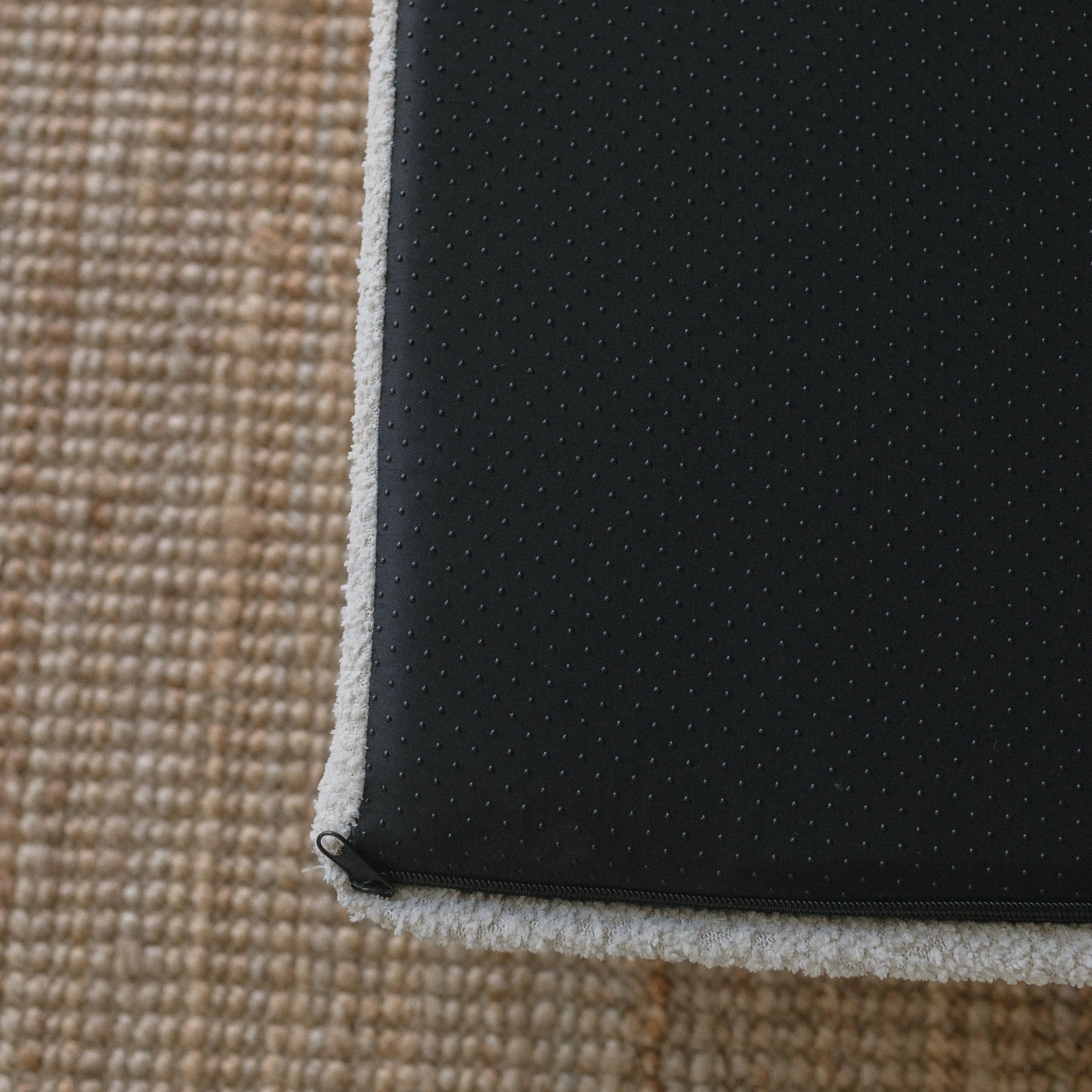 Underside of the dog bed showing the non-slip grip bottom surface