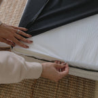 Underside of the dog bed showing the non-slip grip bottom surface and the waterproof cover