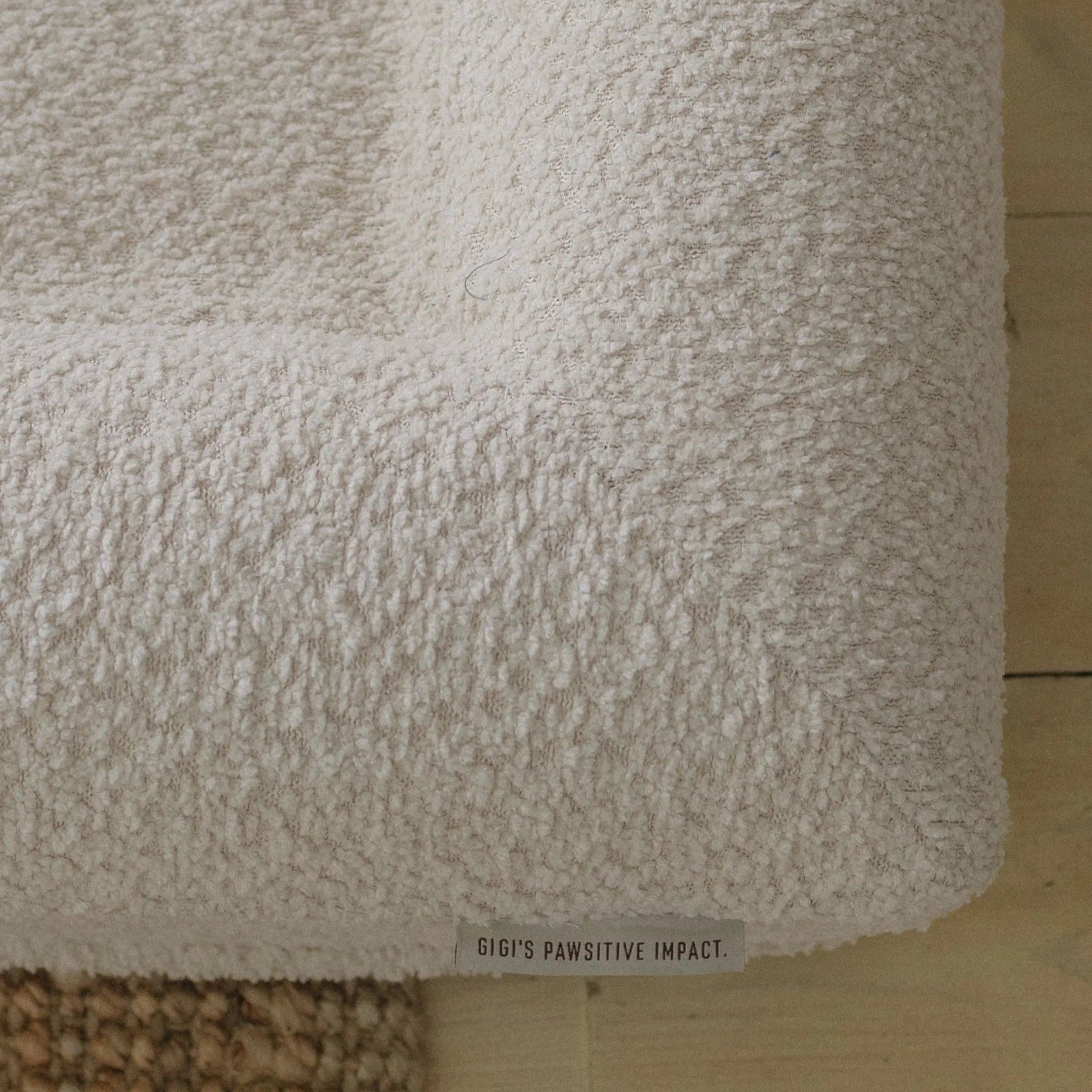 Side view of extra small/small boucle dog bed with plush walls